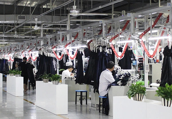 Garments suspended above sewing workstations